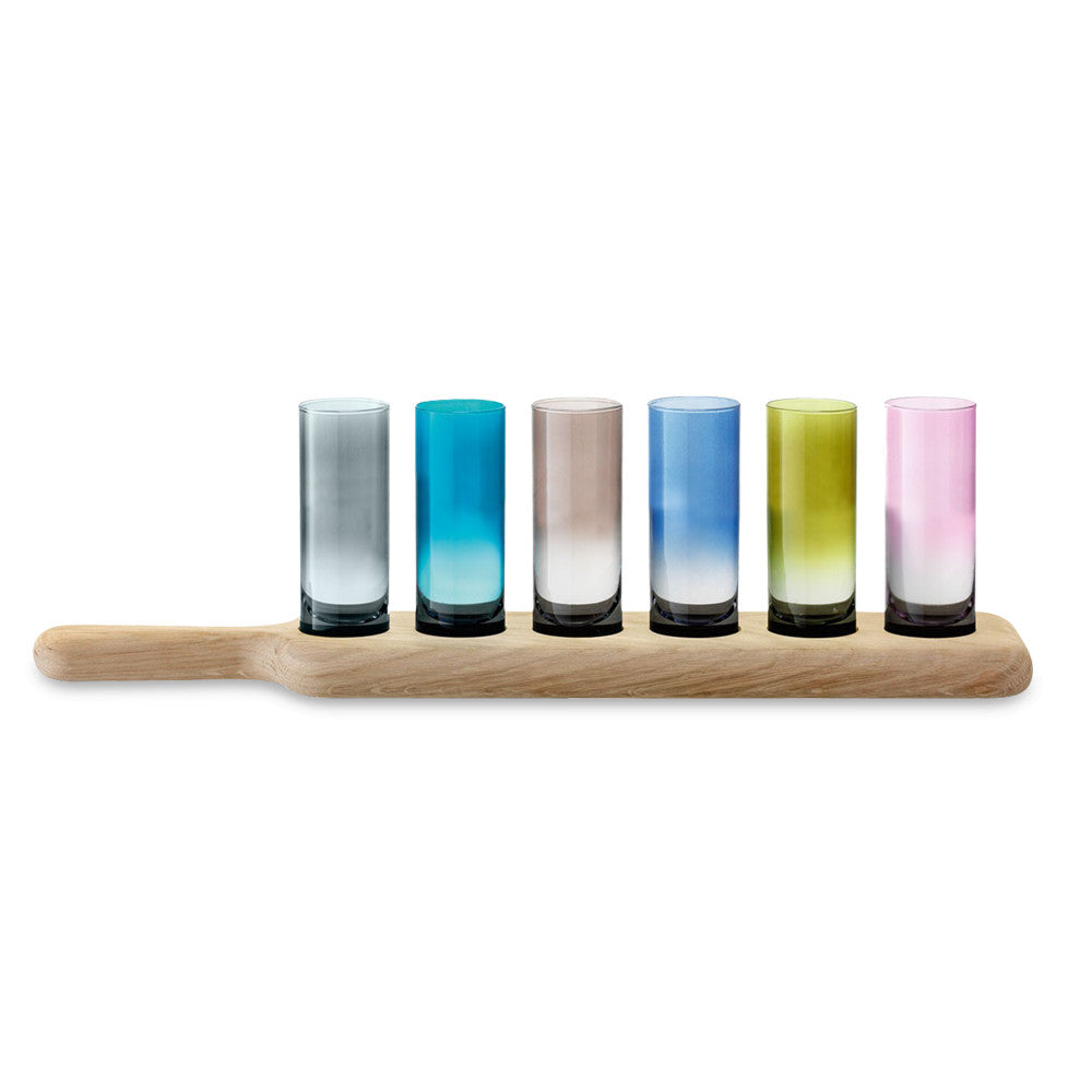 6 colored vodka glasses on wooden paddle